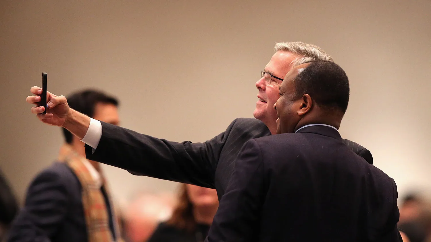 Former Florida Governor Jeb Bush takes a selfie with a guest at a luncheon hosted by the Chicago Council on Global Affairs on February 18, 2015 in Chicago, Illinois.
