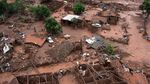 Aerial view of damages after a dam burst in the village of Bento Rodrigues, in Mariana, Minas Gerais state, Brazil on November 6, 2015. A dam burst at a mining waste site unleashing a deluge of thick, red toxic mud that smothered a village killing at least 17 people and injuring some 75. The mining company Samarco, which operates the site, is jointly owned by two mining giants, Vale of Brazil and BHP Billiton of Australia. AFP PHOTO / CHRISTOPHE SIMON (Photo credit should read CHRISTOPHE SIMON/AFP/Getty Images)
