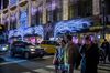 Pedestrians and traffic outside the Saks Fifth Avenue store.