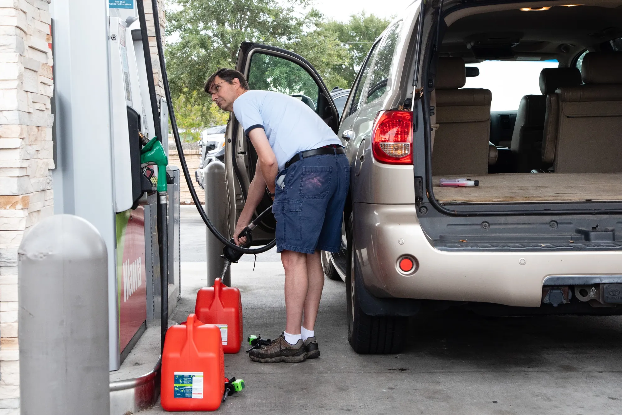 A customer fills canisters at a gas station ahead of Hurricane Ian in St. Petersburg, Florida, on Sept. 27.