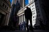 Pedestrians pass in front of the New York Stock Exchange (NYSE) in New York, U.S., on Monday, May 21, 2018. U.S. stocks surged and the dollar strengthened against most major peers and as the Trump Administration sought to deescalate a trade rift with China.
