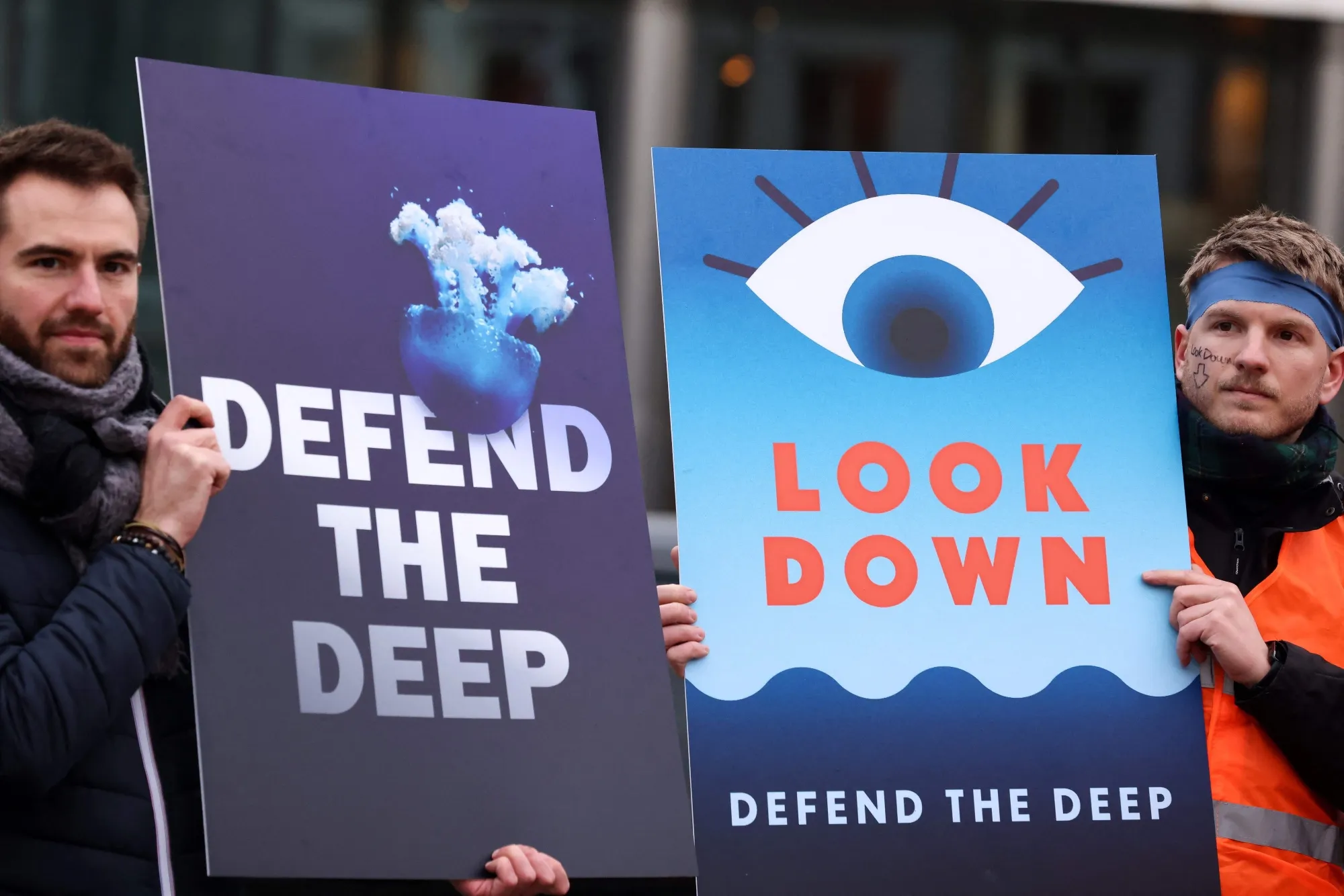 Activists take part at a "Look Down action" rally to stop deep sea mining outside the European Parliament in Brussels on March 6, 2023.