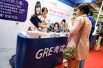 People visit the booth of Education Testing Service to get information about TOEFL (Test of English as a Foreign Language) and GRE (Graduate Record Examination) during the 2014 China International Education Exhibition in Shanghai, China, on Nov. 1, 2014.
