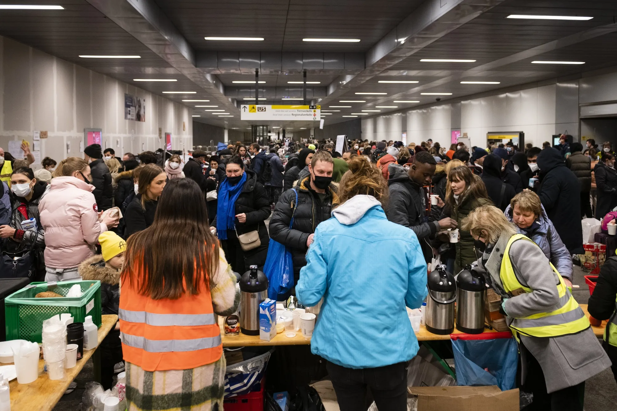 Volunteers offer food and other provisions to displaced Ukrainians on arrival at Berlin Central railway station in March.