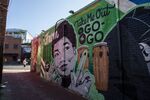 A mural decorates a building behind a Metro PCS store in the Shaw neighborhood of Washington. Go-go music, a distinctive Washington, D.C.-specific offshoot of funk, has endured for decades through cultural shifts, fluctuations in popularity, and law enforcement purges. Now go-go has taken on a new mantle: battle hymn for the fight against a gentrification wave that’s reshaping the city.