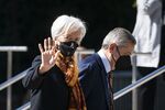 Christine Lagarde, president of the European Central Bank (ECB), left, waves while arriving to the International Monetary Fund (IMF) headquarters during the spring meetings of the IMF and World Bank Group in Washington, D.C., U.S., on Wednesday, April 20, 2022. 