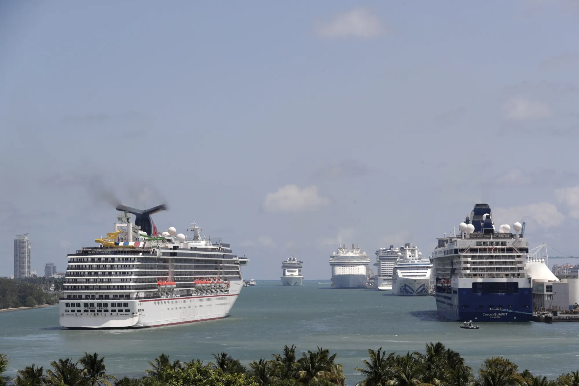 Cruise ships float at PortMiami, on April 7, 2020, in Miami. The trade group representing the cruise ship industry unsuccessfully pushed international authorities to water down new environmental regulations despite members' commitments to addressing climate change, ocean air pollution experts have warned. (AP Photo/Lynne Sladky, File)