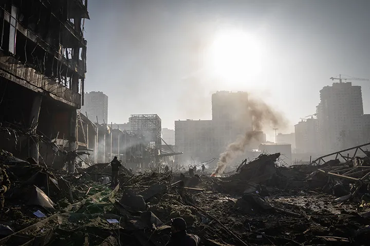 People walk through debris at the Retroville shopping mall following a Russian shelling attack in Kyiv, Ukraine, on March 21.