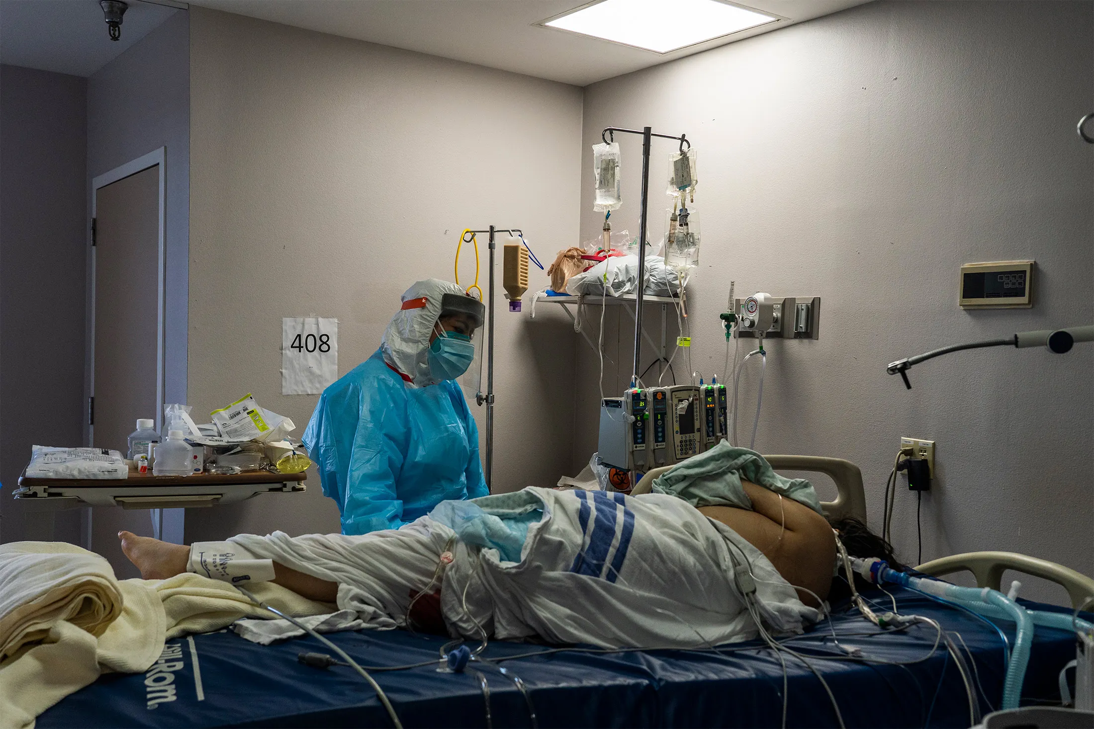 A medical staff member stands by a Covid-19 patient&nbsp;on Christmas Eve at a hospital in Houston, Texas.&nbsp;