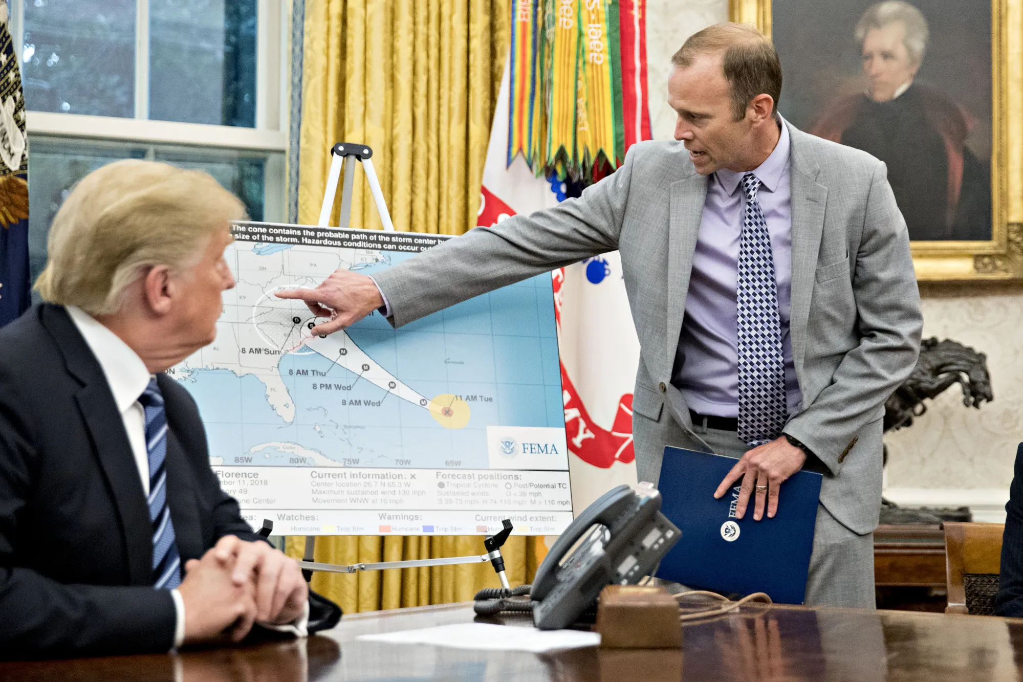 Brock Long, right, speaks to Donald Trump at the White House