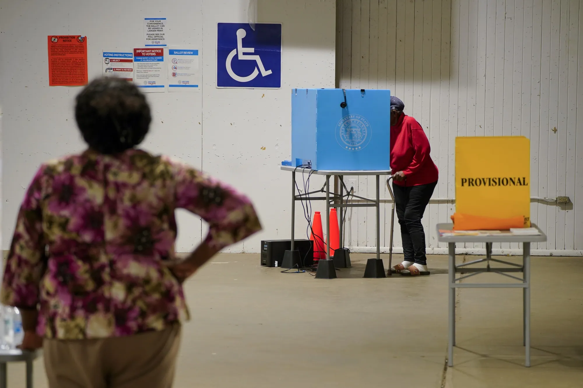 A person uses a voting machine to fill out and cast their ballot as early voting continues for the midterm elections at a polling location in Americus, Georgia,&nbsp;on Oct. 25, 2022.&nbsp;
