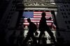 Pedestrains walk outside the New York Stock Exchange in New York, U.S., on Friday, July 17, 2009. Most U.S. stocks fell, trimming the best weekly gain since March for the Standard & Poor's 500 Index, as lower profit at General Electric Co. and slowing sales growth at Google Inc. offset a jump in housing starts.