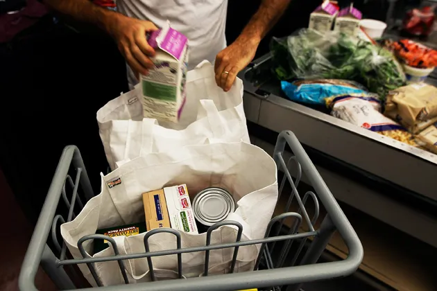 A shopper packs groceries into reusable bags in Brooklyn, N.Y.