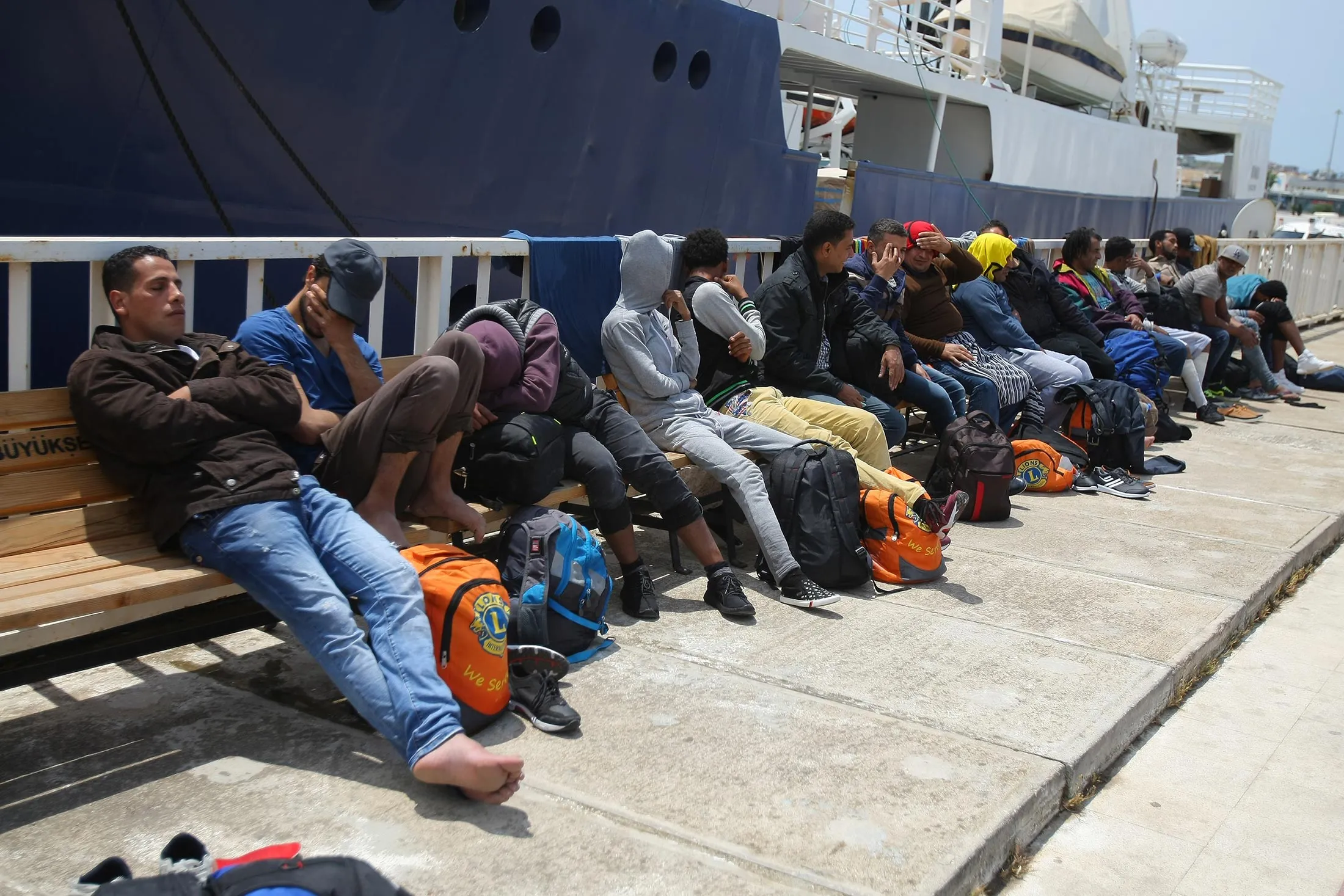 A group of refugees wait after they were captured by coast guard while trying to pass illegally to Chios of Greek from Cesme in Izmir, Turkey on May 24, 2016. Turkish coast guard captured approximately 42 refugees after the operation.
