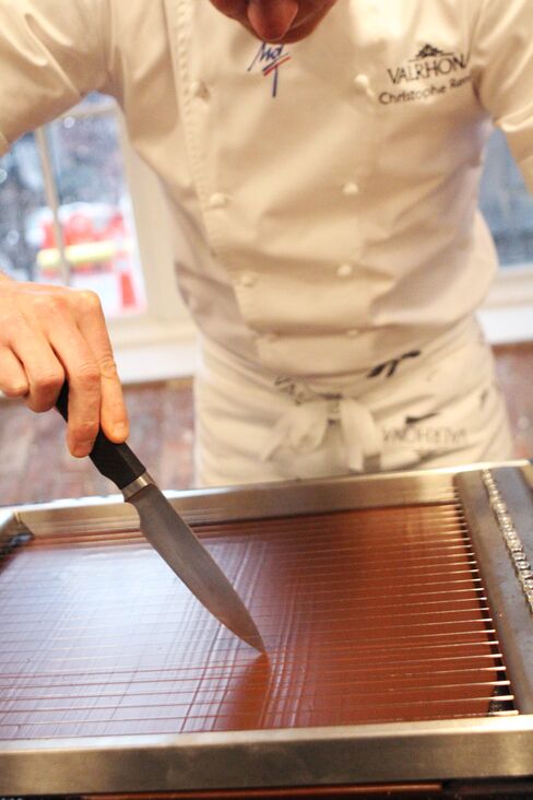 Executive Pastry Chef Christophe Renou cuts bonbons in the test kitchen.