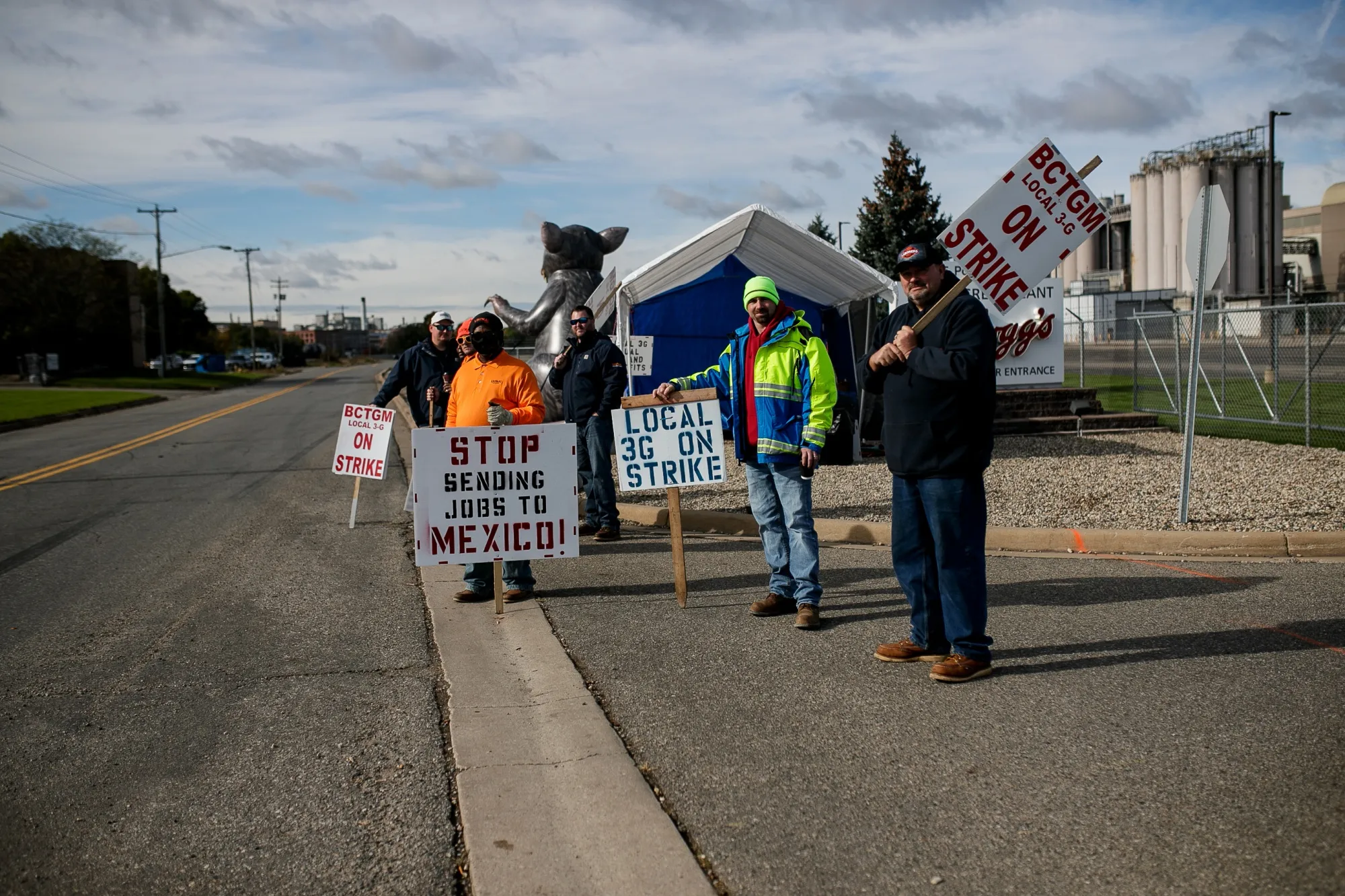 Demonstrators hold signs during a union workers strike outside the Kellogg plant in Battle Creek, Michigan, on Oct. 22.