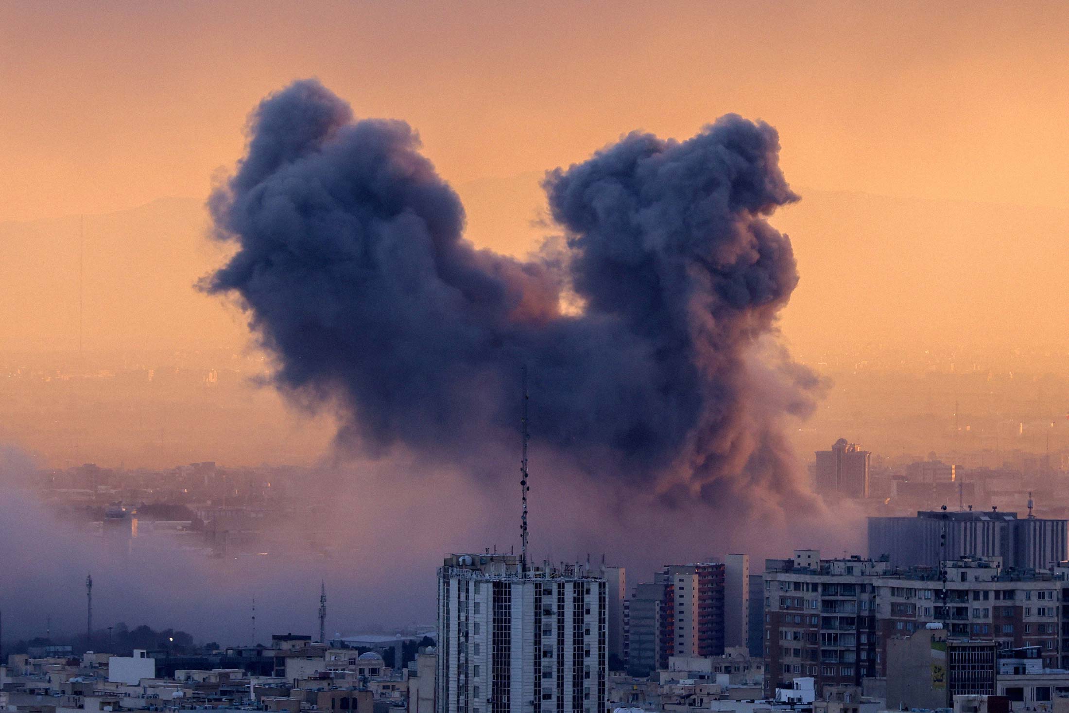 A plume of smoke rises after a strike on the Iranian capital Tehran, on March 3, 2026. Photographer: Atta Kenare/AFP/Getty Images
