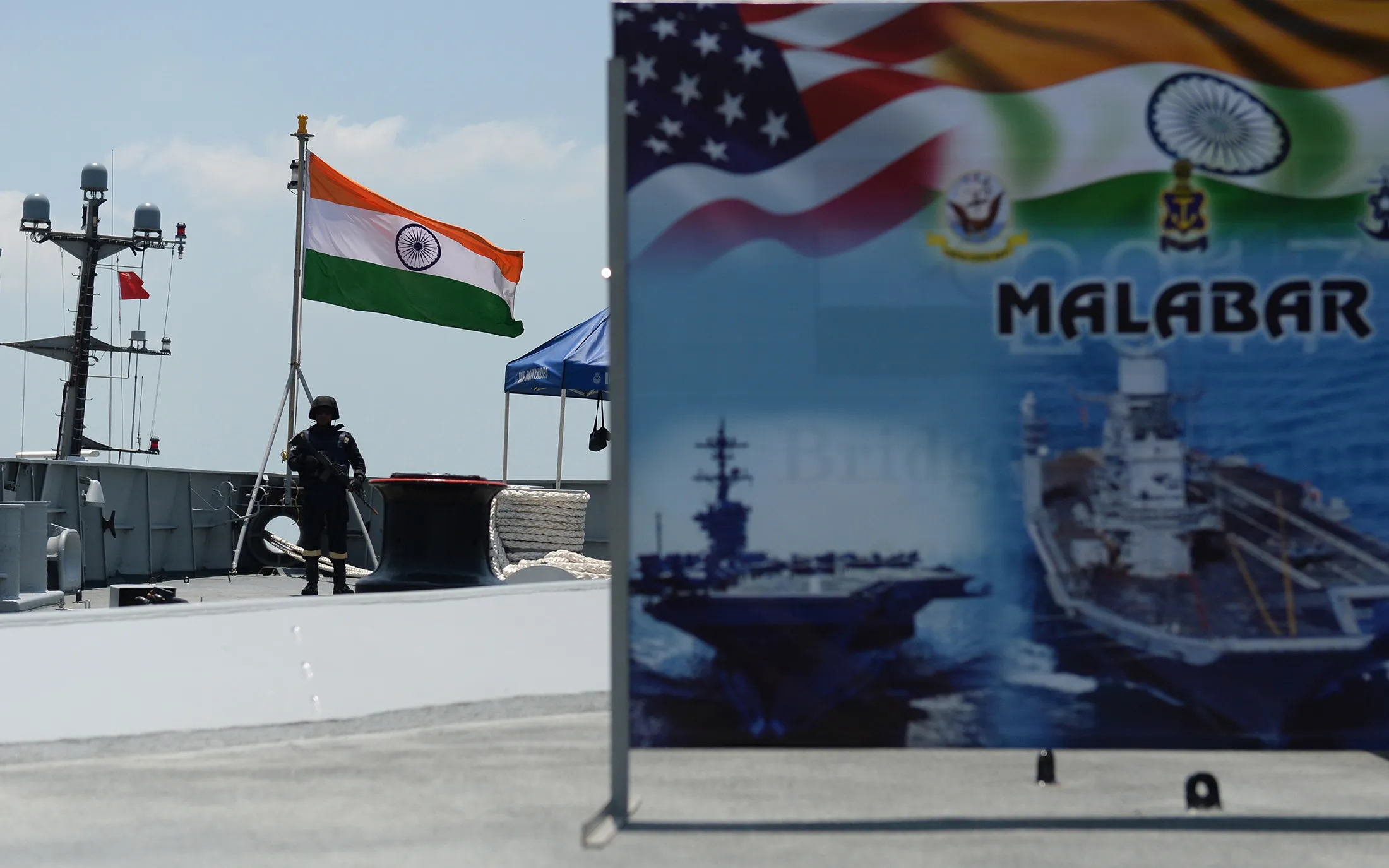 An Indian Navy sailor stands guard on the deck of the INS Shivalik during the inauguration of joint naval exercises with the United States and Japan in Chennai, India in 2017.