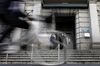 A cyclist rides pasts a security guard standing outside the Bank of Japan (BOJ) headquarters in Tokyo.