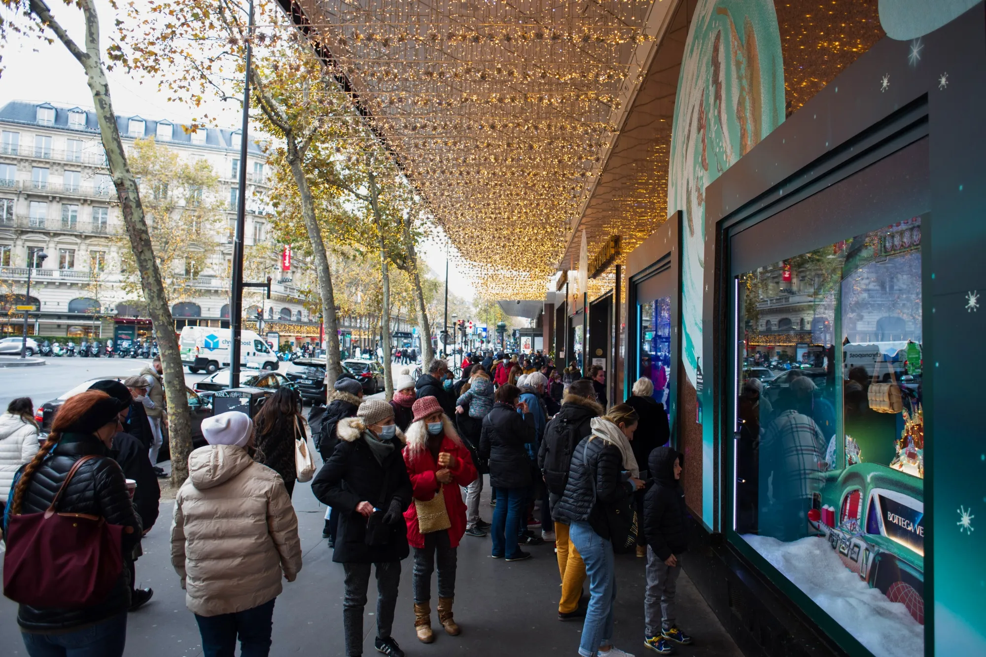 Shoppers look at festive window decorations at the Galeries Lafayette department store, in Paris, France.