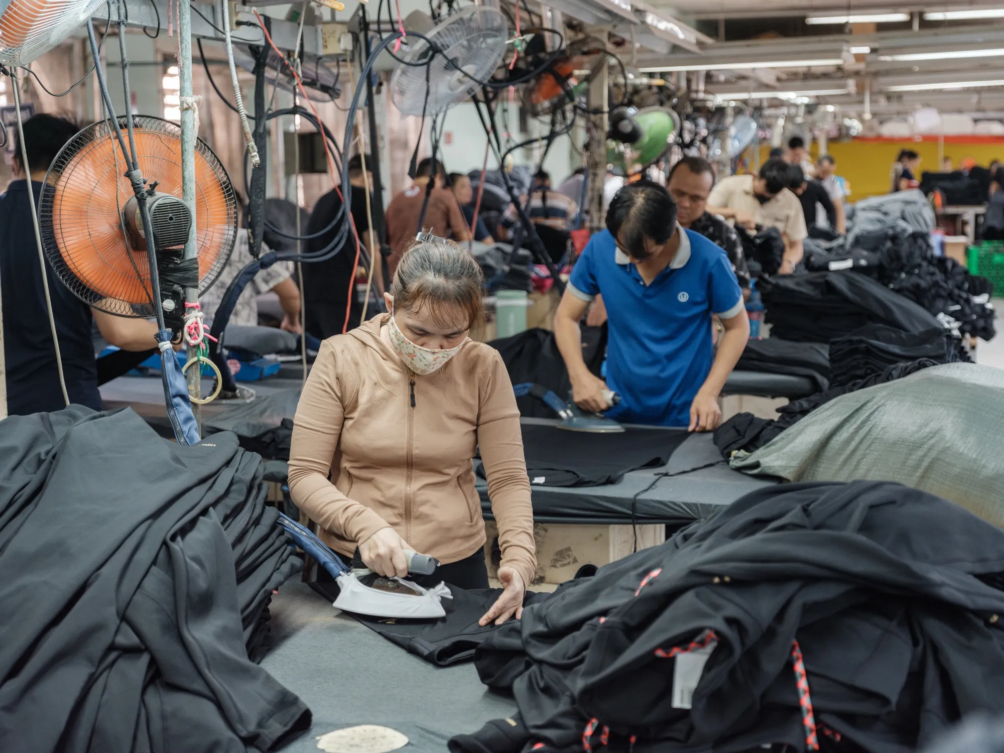 Workers iron items of clothing at a&nbsp;garment factory in Binh Thuan province, Vietnam.