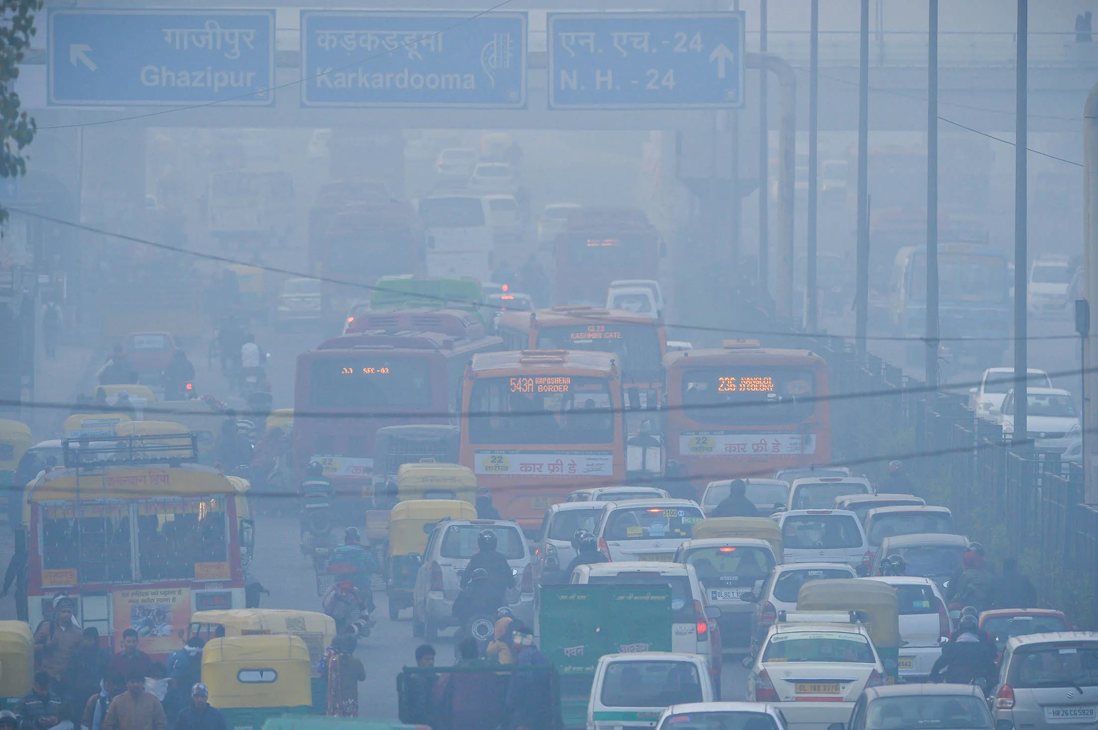 To go with India-environment-pollution,FOCUS by Trudy Harris In this photograph taken on December 18, 2015, Indian commuters travel on a polluted road near a bus terminus in the Anand Vihar District of New Delhi. Anger and alarm are rapidly rising throughout sprawling New Delhi over the air quality that the World Health Organization (WHO) has ranked the most hazardous on the planet. AFP PHOTO / CHANDAN KHANNA / AFP / Chandan Khanna (Photo credit should read CHANDAN KHANNA/AFP/Getty Images)
