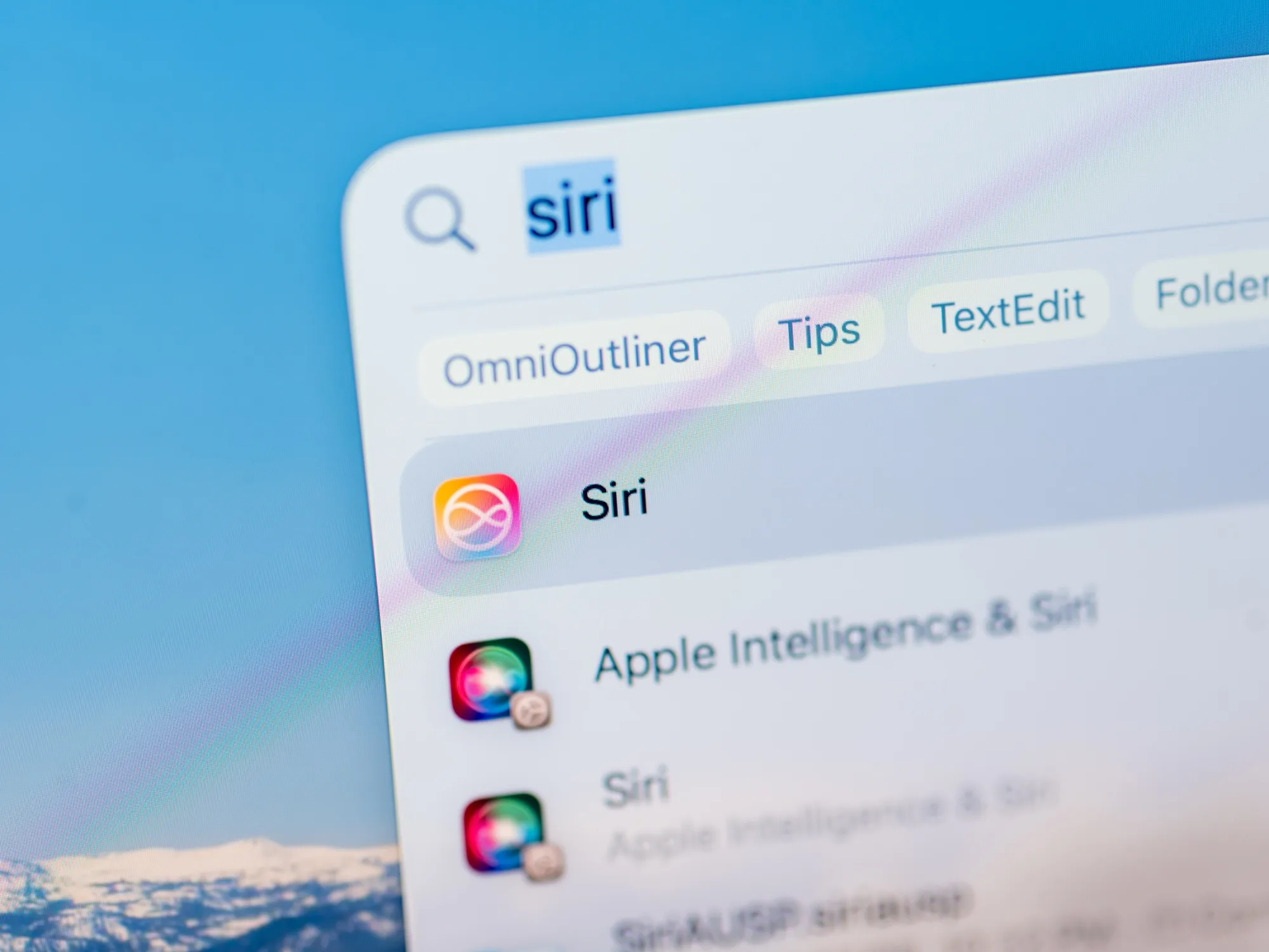 The Apple Siri icon on a Macbook Pro laptop.