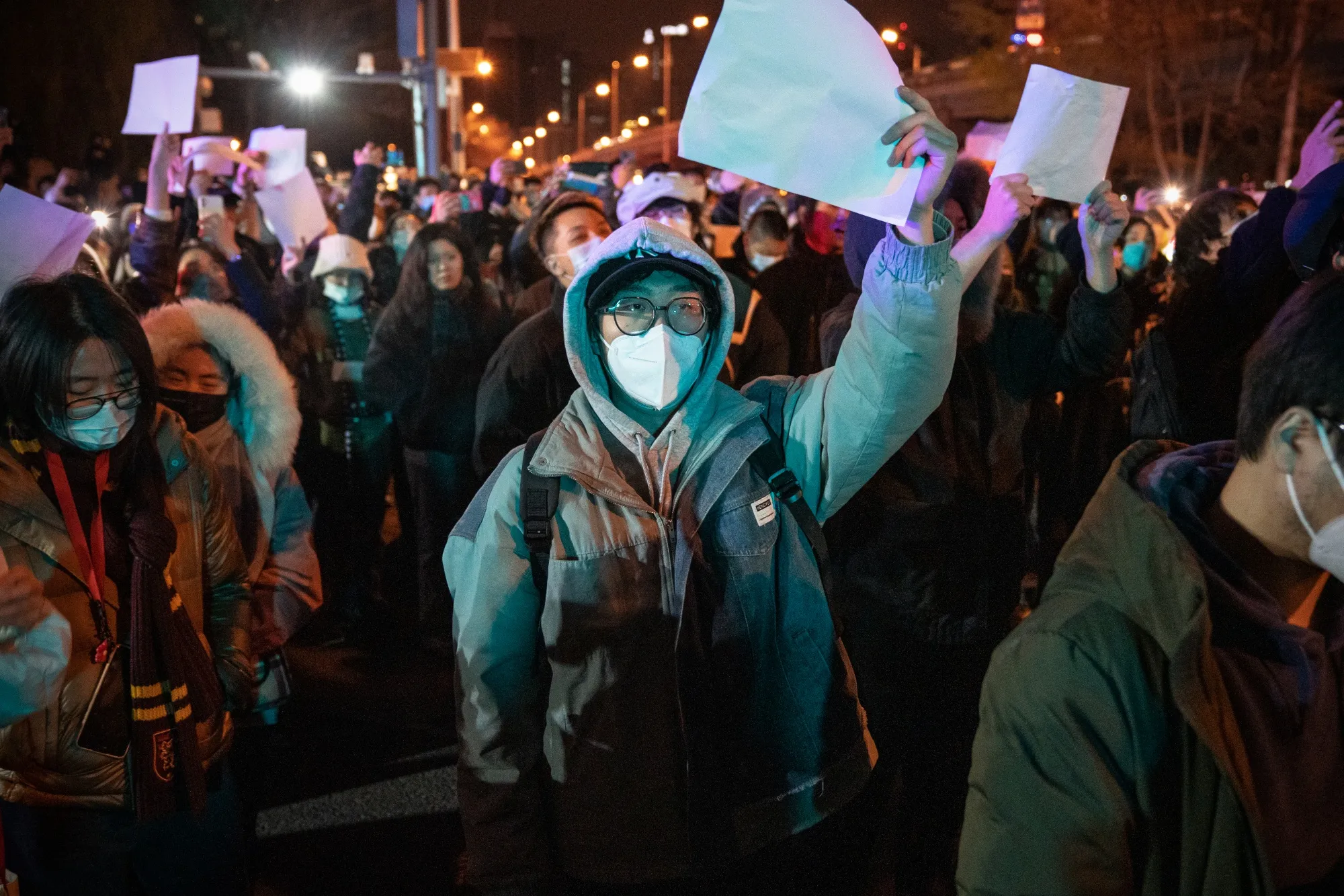 Demonstrators hold blank signs during a protest in Beijing.