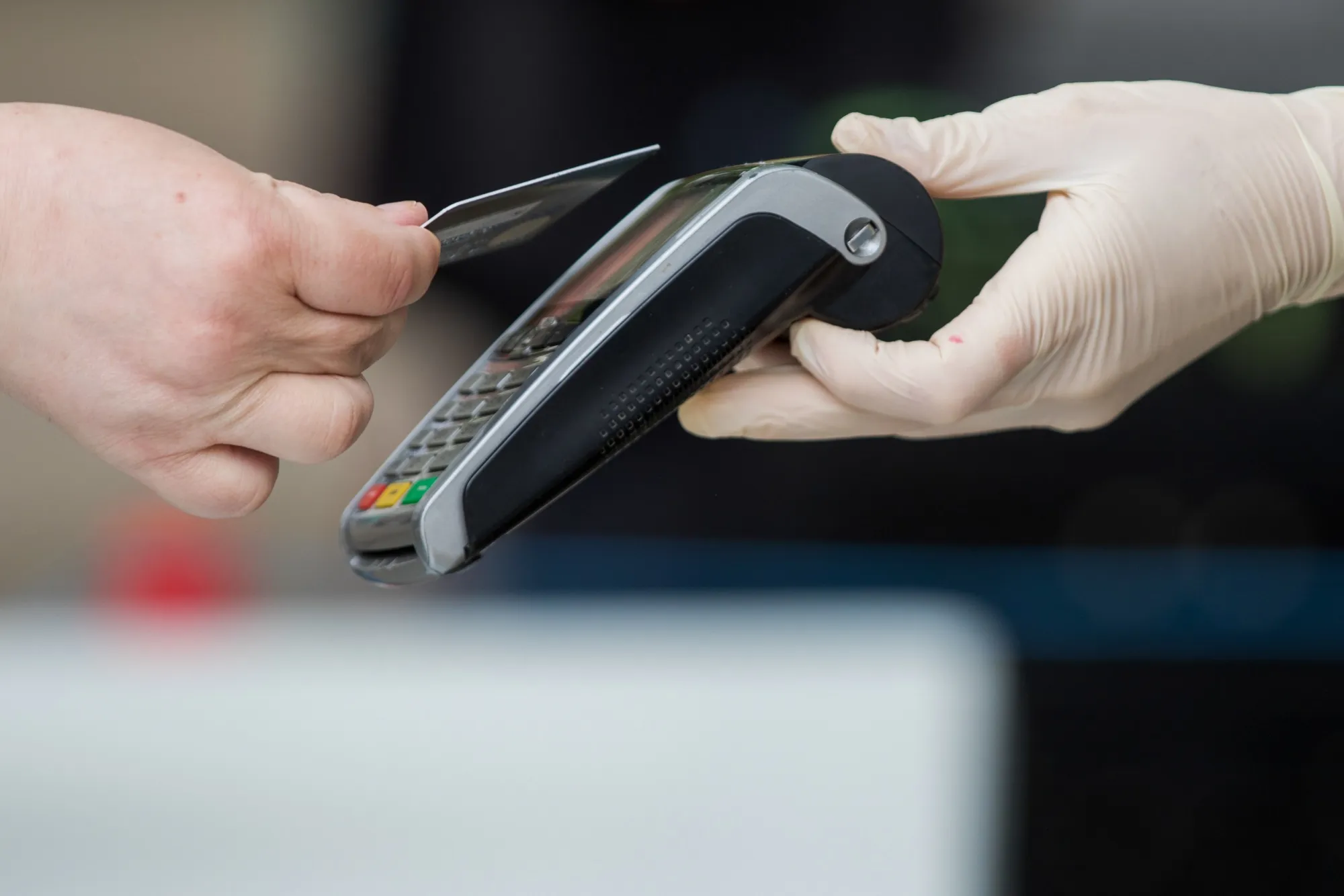 A customer uses a bank card to make a contactless payment.