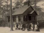 Black school children pose with their teacher outside a segregated one-room school in South Carolina, 1916.