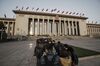 Members of the media wait in line outside of the Great Hall of the People for the closing ceremony of the National People's Congress (NPC) in Beijing, China.