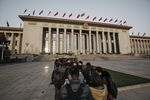 Members of the media wait in line outside of the Great Hall of the People for the closing ceremony of the National People's Congress (NPC) in Beijing, China.
