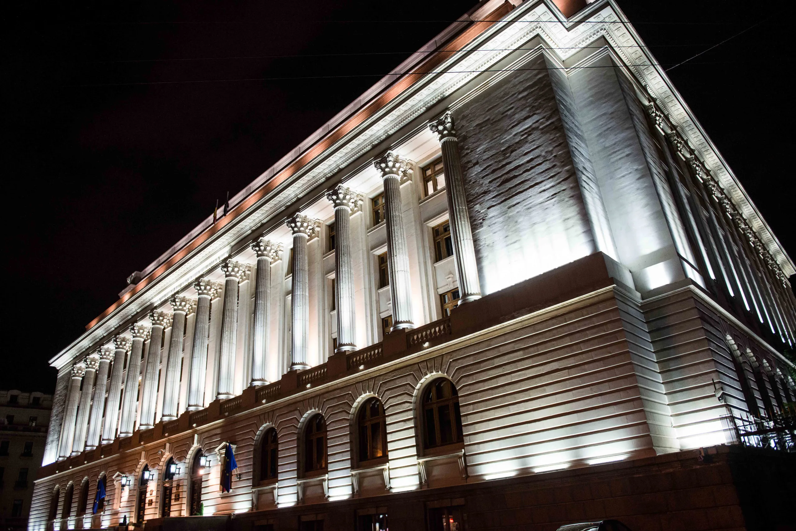 Lights shine on the exterior of the Romanian central bank, the Banca Nationala A Romaniei, as the building is illuminated at night in Bucharest, Romania, on Thursday, June 11, 2015.&nbsp;