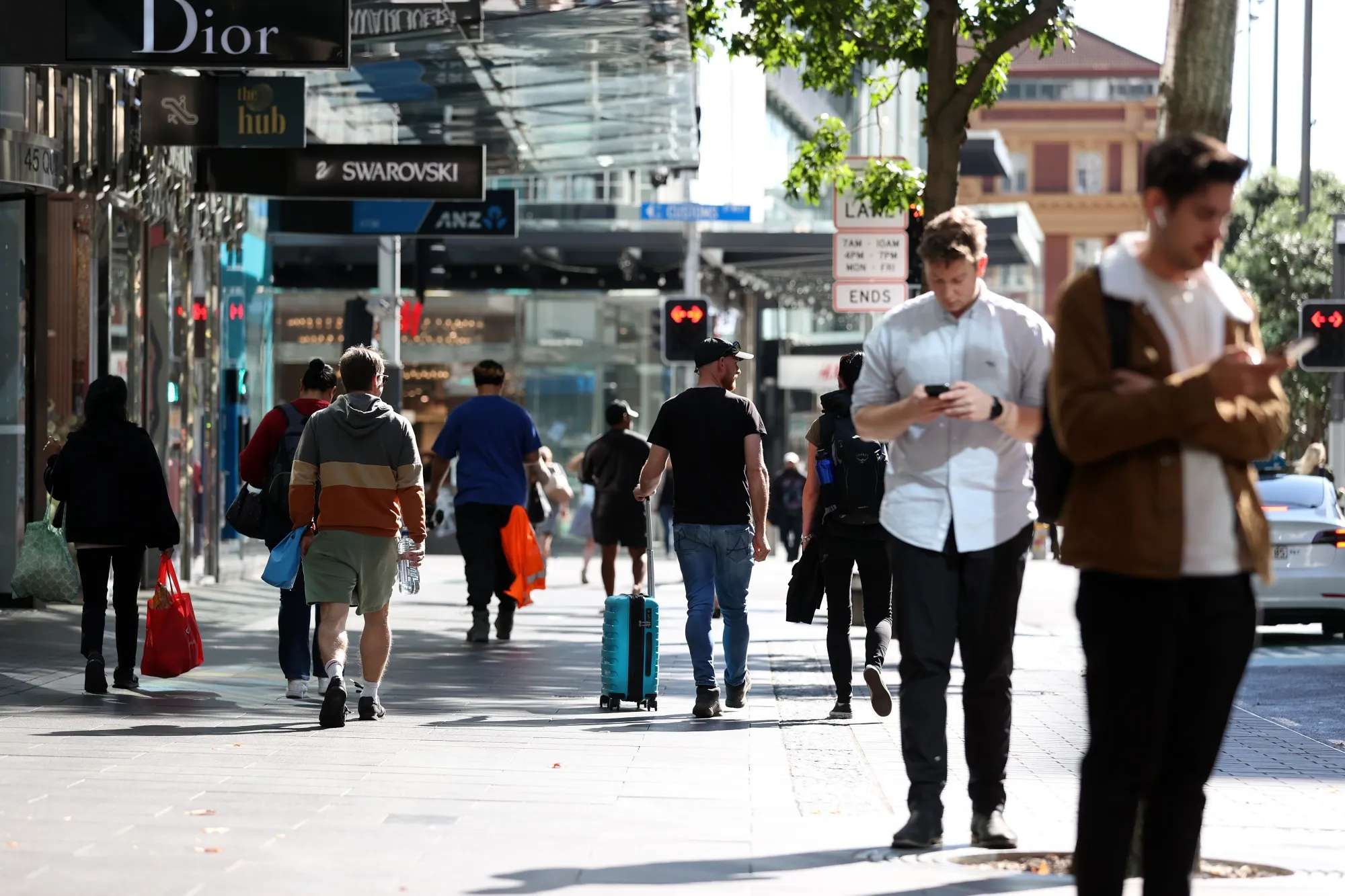 Pedestrians along Queen Street in Auckland, New Zealand.