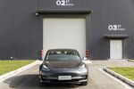 A Tesla Model 3 vehicle sits parked outside a gate to the the company's Gigafactory in Shanghai, China.