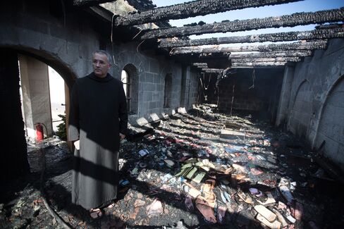 A Priest Inspects Damage at Tabgha Church
