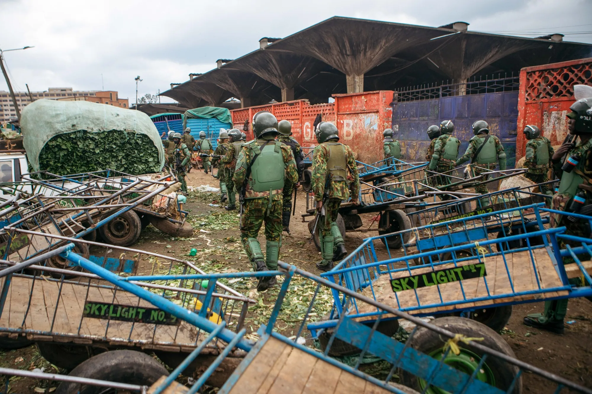 Armed police officers patrol a market during protests in the central business district of Nairobi.
