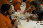 Deanna Van Buren, right, works with an inmate on a restorative justice design.