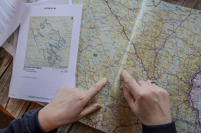 Fingers pointing on a map of Sweden