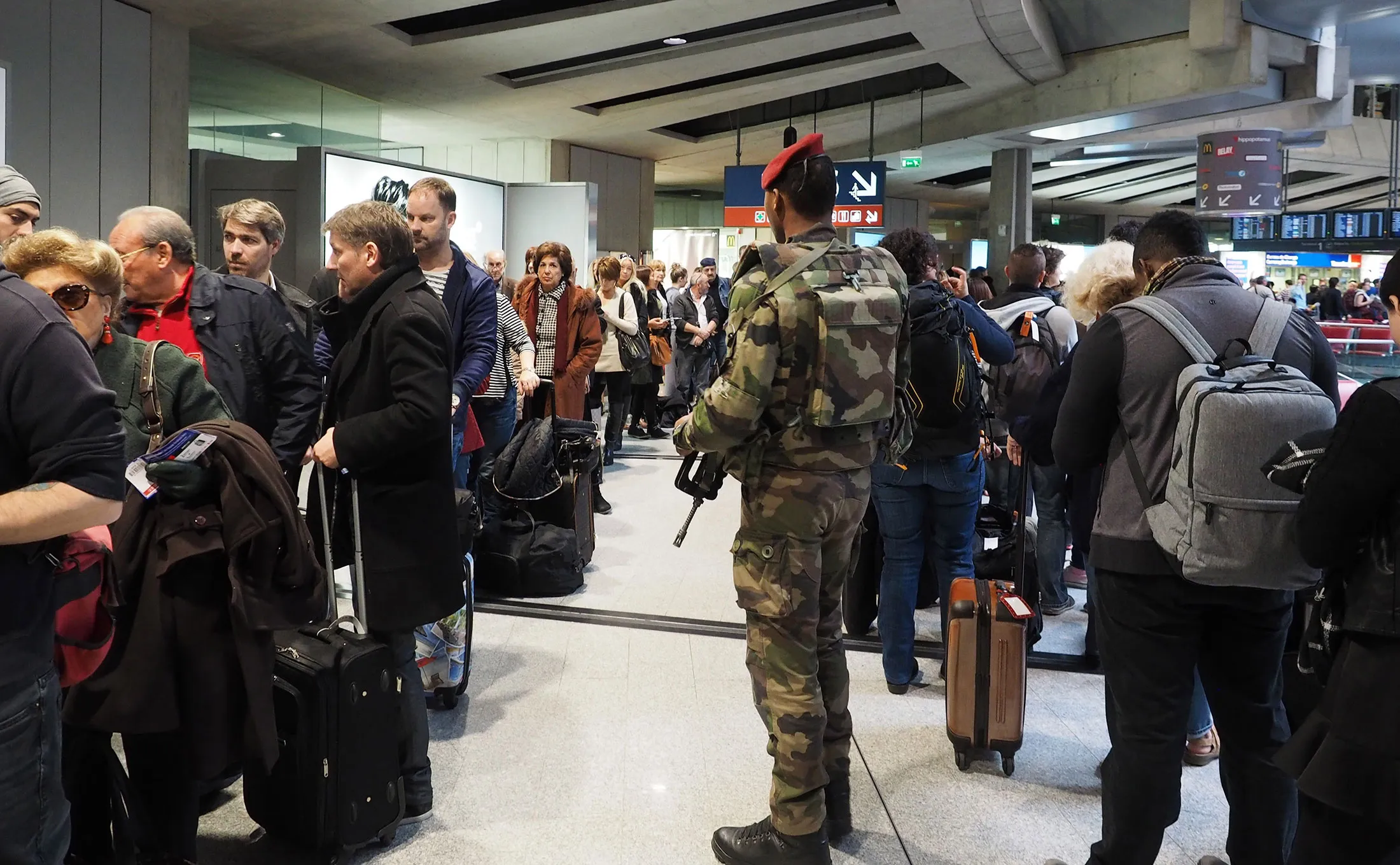 A soldier is seen as tourists wait in queues after they swarmed Charles De Gaulle airport in Paris, France on Nov. 14.
