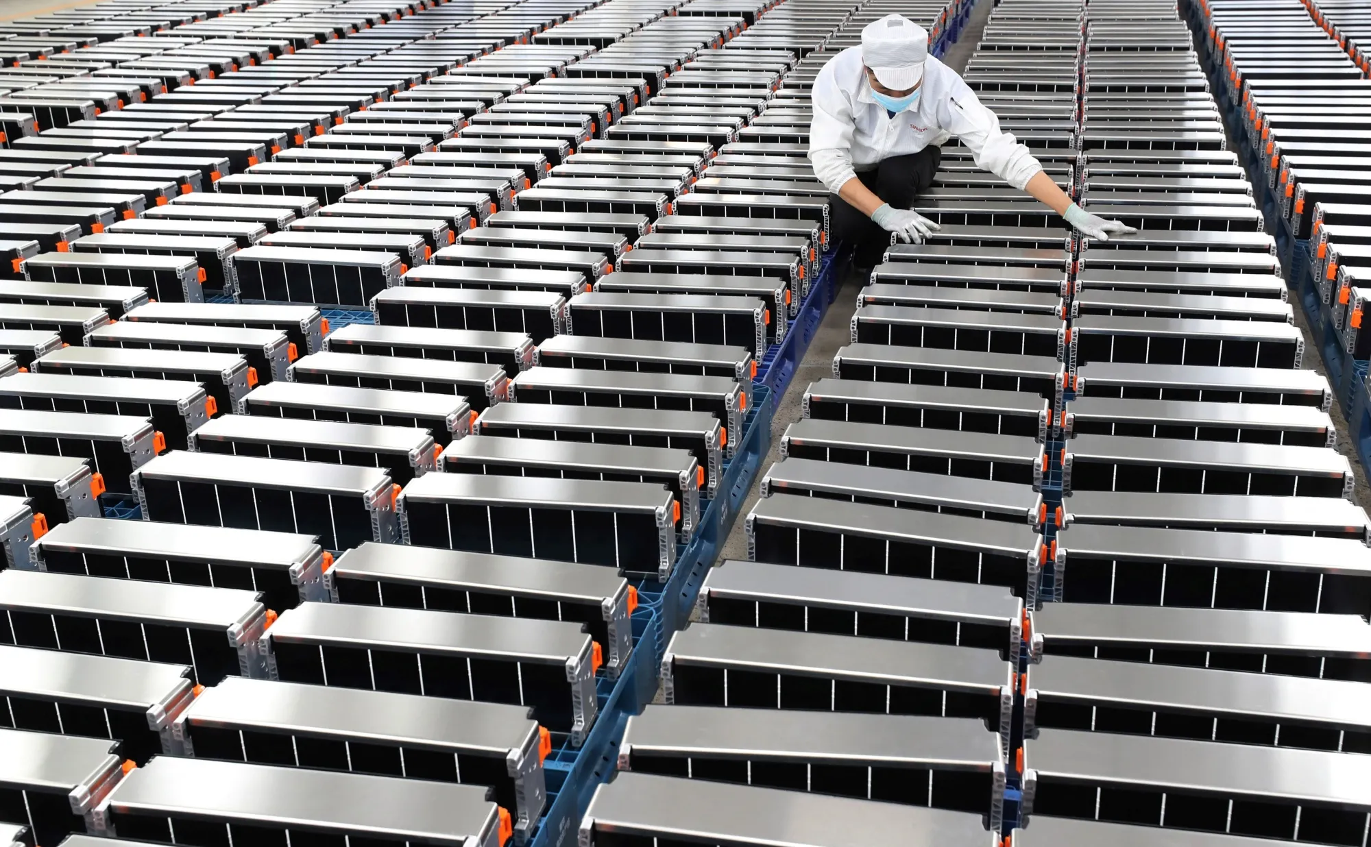 A worker with lithium car batteries at&nbsp;Xinwangda Electric Vehicle Battery factory in Nanjing, China.