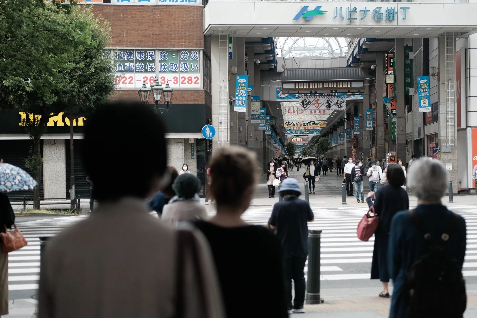 Pedestrians wait to cross a road in Sendai, Miyagi Prefecture, Japan, on May 15.