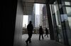 People walk out of a building in Beijing's central business district on January 18, 2019. - China's economy grew at its slowest pace in almost three decades in 2018, analysts in an AFP poll said, as the government struggles to contain ballooning debt and a bruising trade war with the United States. (Photo by GREG BAKER / AFP) (Photo credit should read GREG BAKER/AFP/Getty Images)