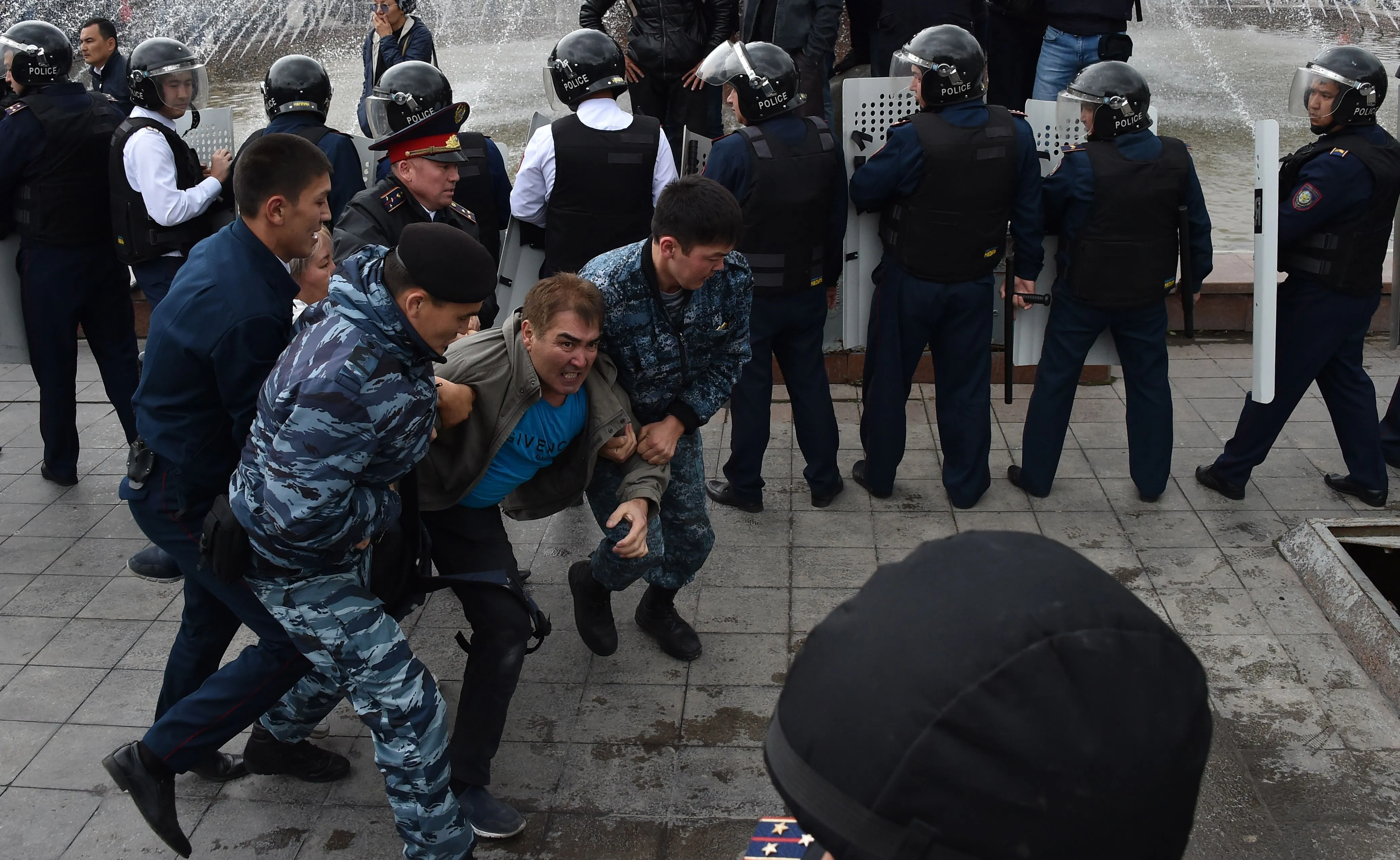Police officers detain opposition supporters during a rally in Nur-Sultan on June 9.