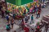 Shoppers pass in front of a fruit stand at an indoor market in Sao Paulo, Brazil, on Tuesday, Feb. 27, 2018. The Central Bank of Brazil is scheduled to release Gross Domestic Product (GDP) figures on March 19.