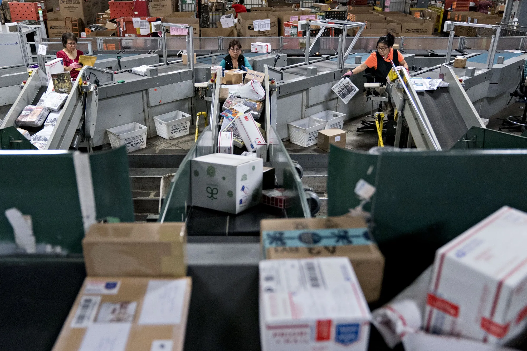 Workers sort packages at a&nbsp;United States Postal Service (USPS)&nbsp;processing and distribution center.