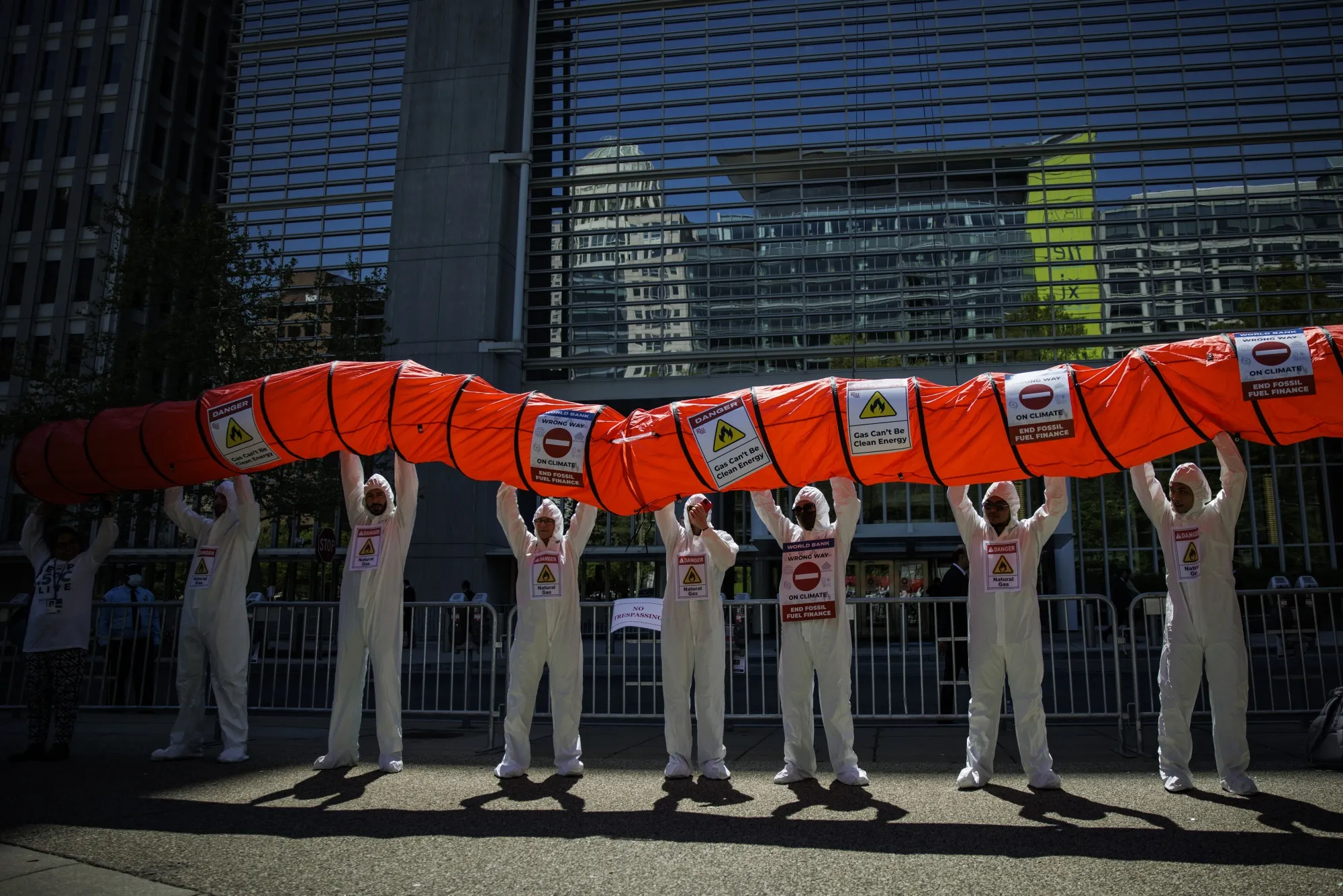 Demonstrators hold up a mock pipeline at a "Stop Fossil Gas" protest outside the World Bank headquarters in Washington, on April 12.