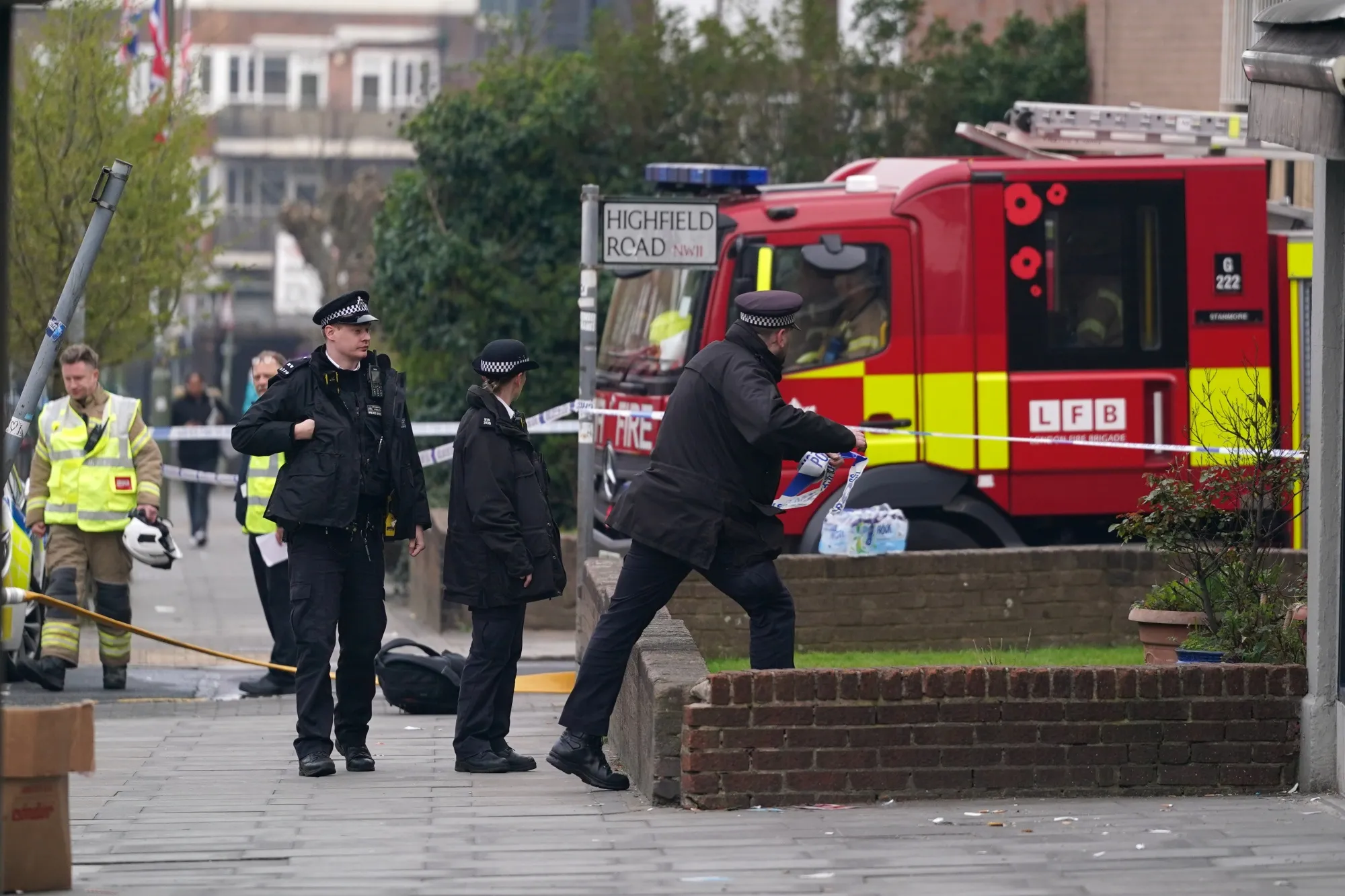 Firefighters and police respond to a fire in Golders Green, London, on March 23.