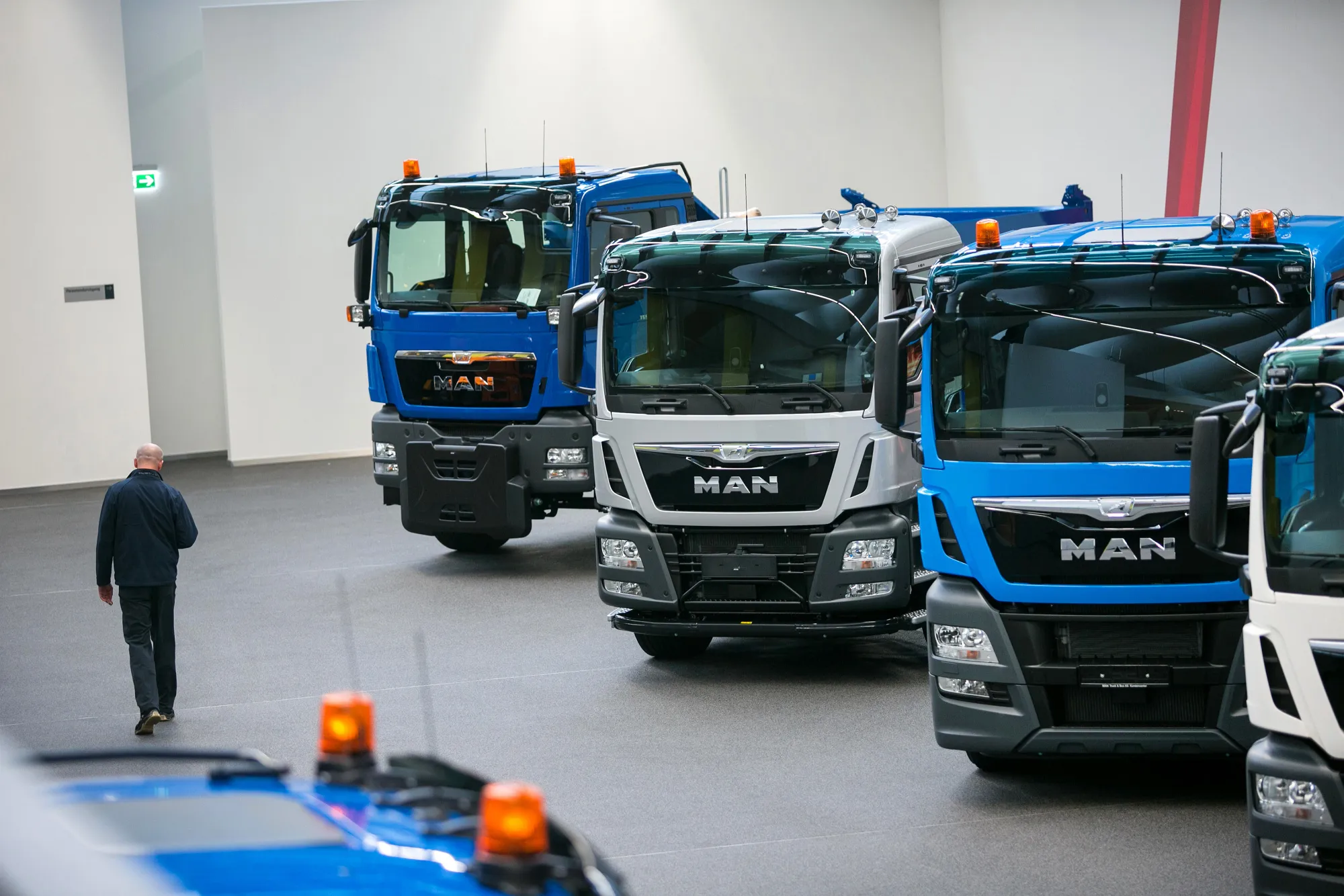 Heavy goods trucks stand inside the MAN SE forum at the headquarters of Volkswagen AG's commercial-vehicle unit in Munich, Germany, on Wednesday, Feb. 3, 2016. An index of German manufacturing activity published on Monday declined to a three-month low, with new orders falling to the weakest level since September.
