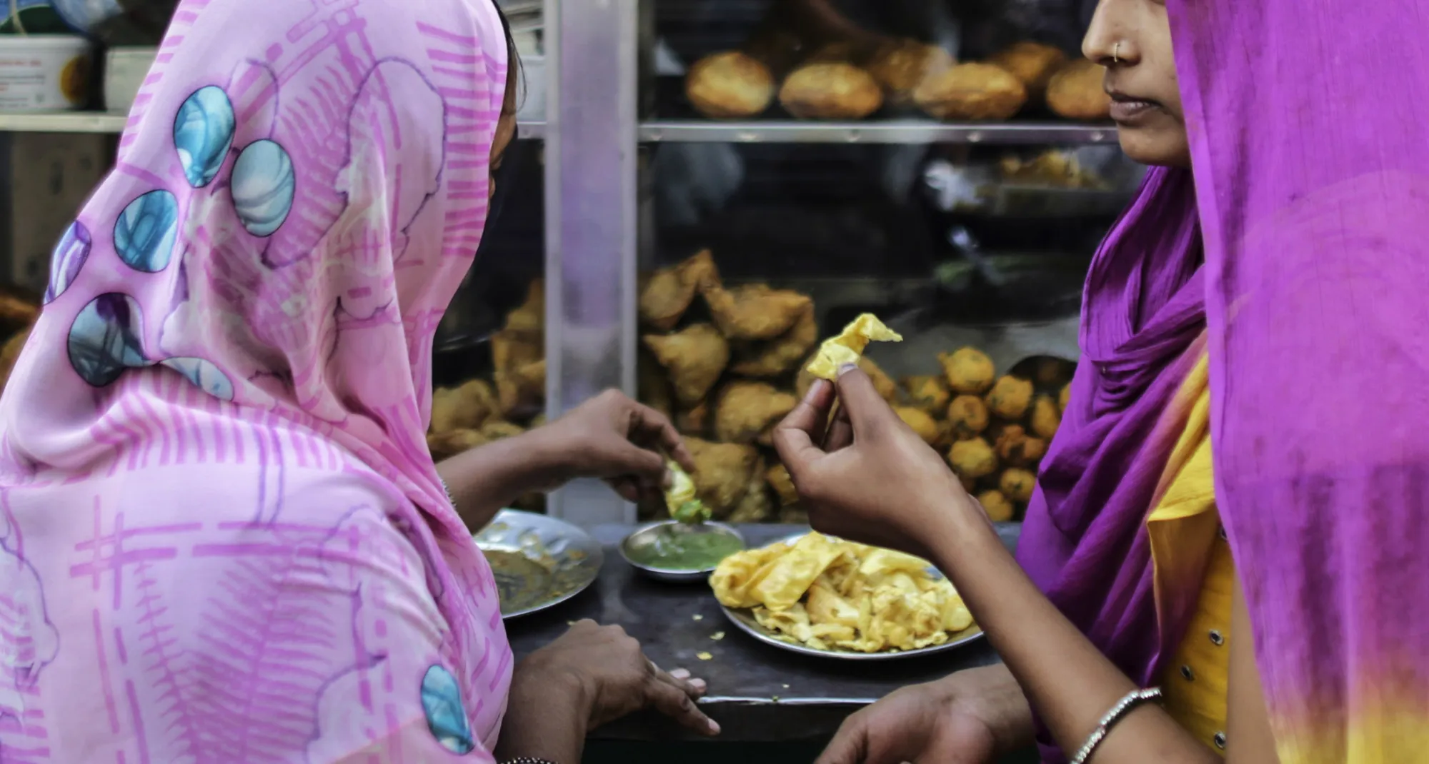 Customers eat at a food stall in Ahmedabad, India, on Dec. 14, 2015.

